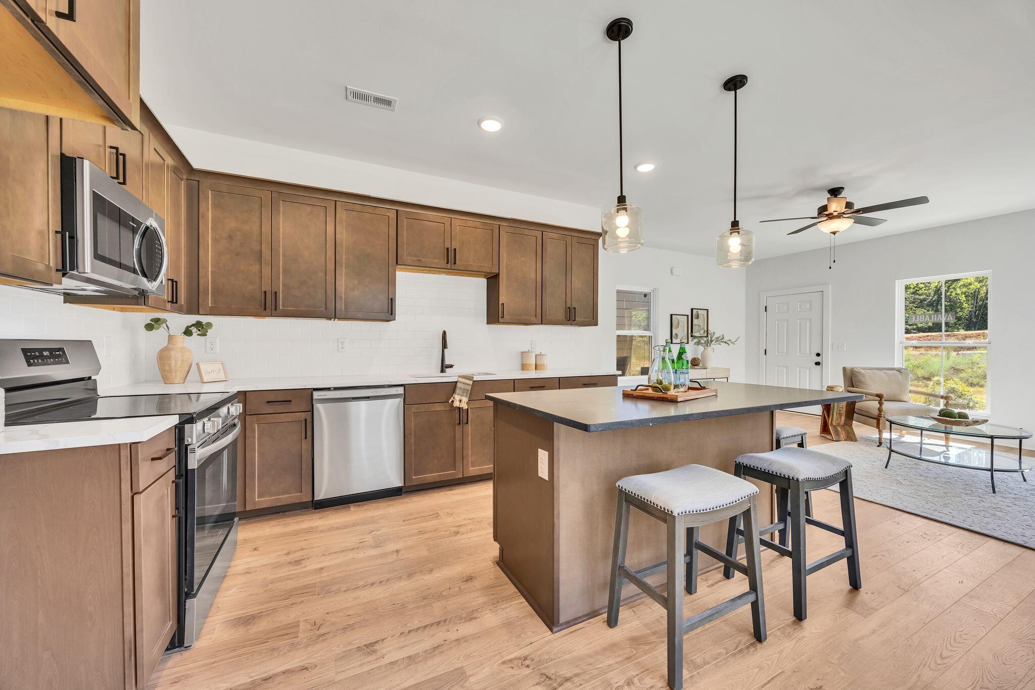 1809 Cotton Way Chattanooga, TN 37404 - Photo 10 of 27 a kitchen with stainless steel appliances granite countertop a sink a stove a refrigerator cabinets and chairs