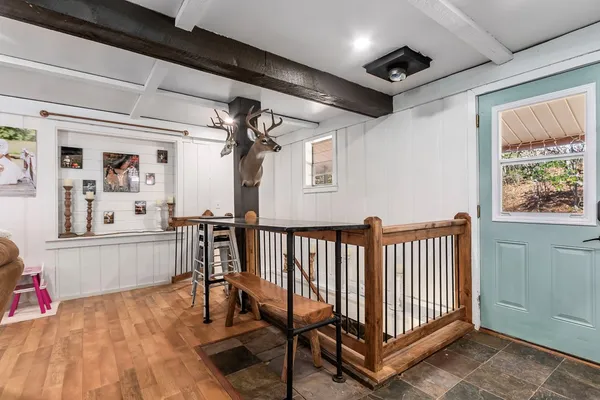a view of a hallway with workspace and wooden floor