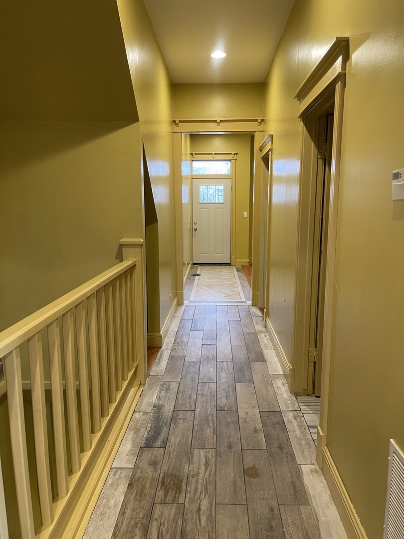 3341 West Walnut Street, Unit 1 Chicago, IL 60624 - Photo 4 of 10 a view of a hallway with wooden floor