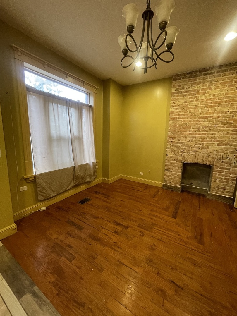 3341 West Walnut Street, Unit 1 Chicago, IL 60624 - Photo 5 of 10 a view of an empty room with a fireplace