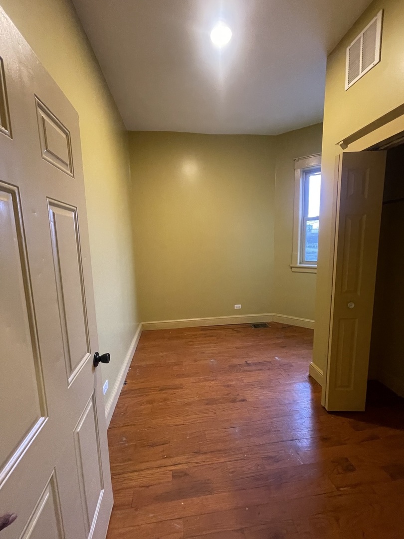 3341 West Walnut Street, Unit 1 Chicago, IL 60624 - Photo 7 of 10 a view of an empty room with a fireplace