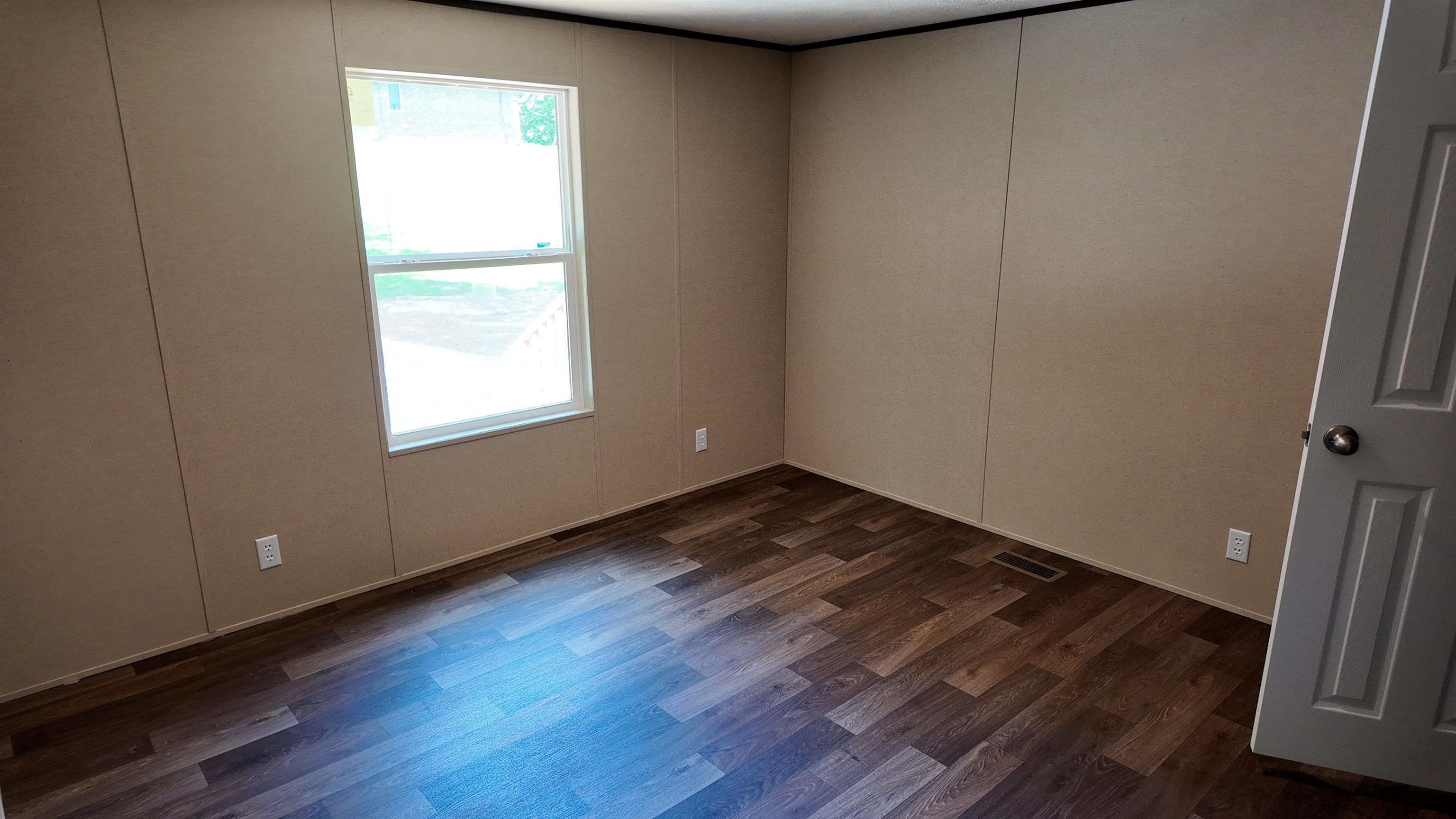 208 Marcy Cove Ripley, TN 38063 - Photo 10 of 14 Empty room featuring dark wood-style flooring
