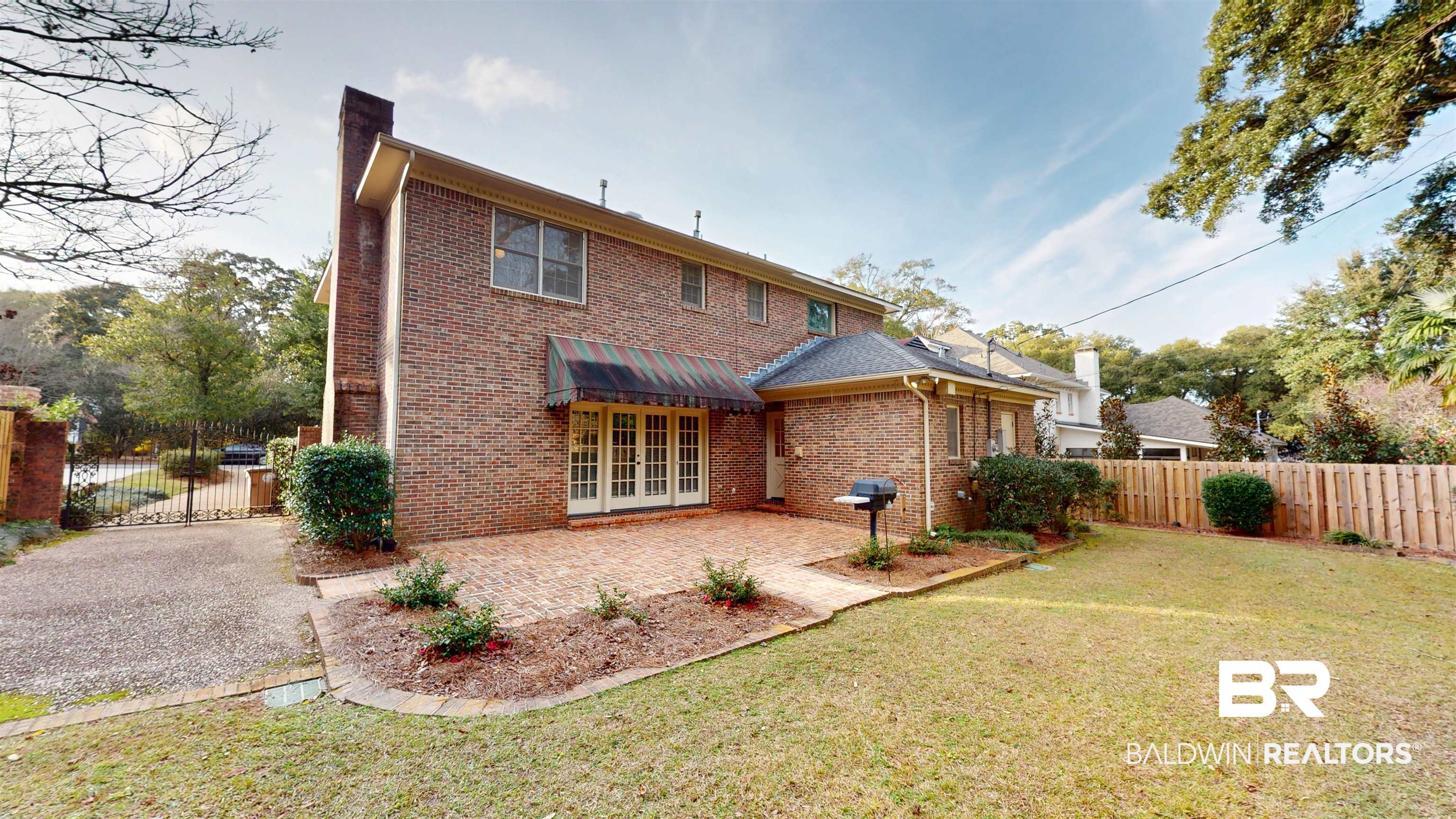 53 Warwick Road Mobile, AL 36608 - Photo 10 of 45 Rear view of house featuring a fenced backyard, a chimney, a patio, and brick siding