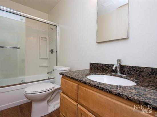 2900 Yulupa Avenue Santa Rosa, CA 95405 - Photo 9 of 11 a bathroom with a granite countertop sink toilet a mirror and shower