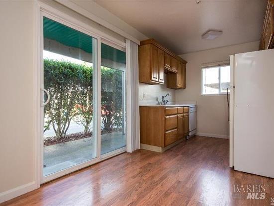 2900 Yulupa Avenue Santa Rosa, CA 95405 - Photo 10 of 11 a kitchen with stainless steel appliances granite countertop a refrigerator a sink and a stove with wooden floor