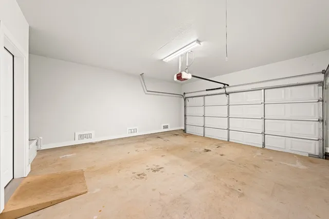 an empty room with projector & cabinets