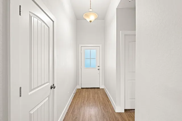 a view of a room with wooden floor and bathroom view