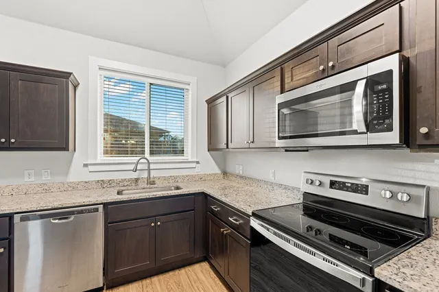 a kitchen with a stove microwave and sink