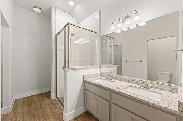 a bathroom with a sink mirror and a shower