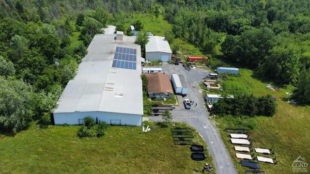 an aerial view of multiple houses with yard
