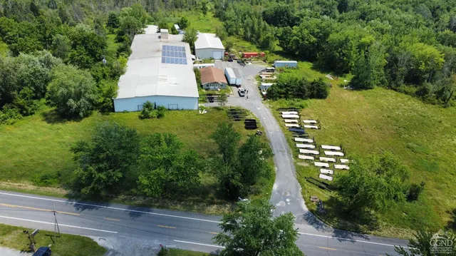 an aerial view of a house with outdoor space pool seating area and yard