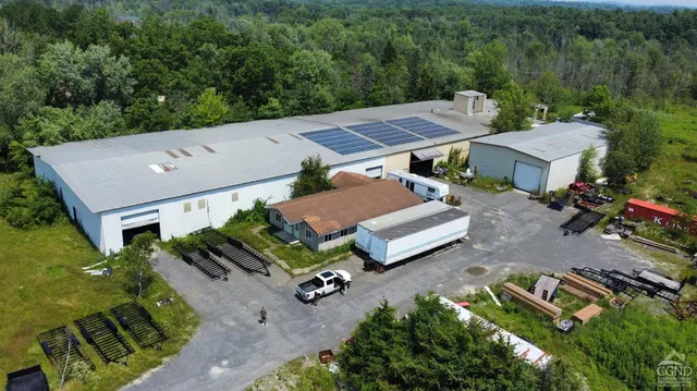 an aerial view of a house with garden space and street view