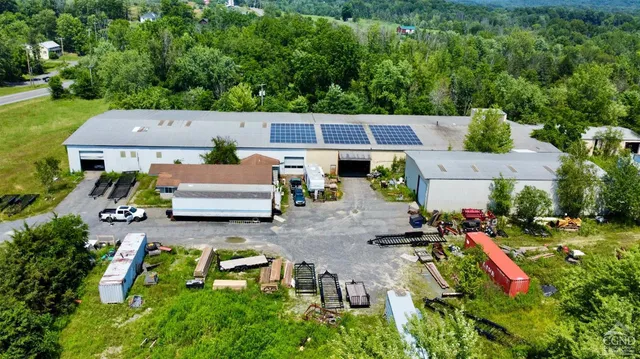 an aerial view of a house with a yard basket ball court and outdoor seating