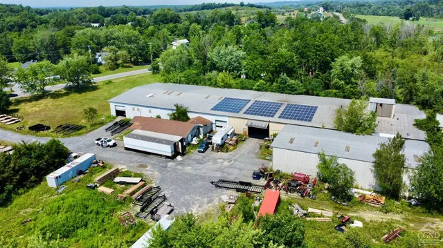 an aerial view of a house with garden space and street view