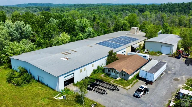 an aerial view of a house with a yard and lake view
