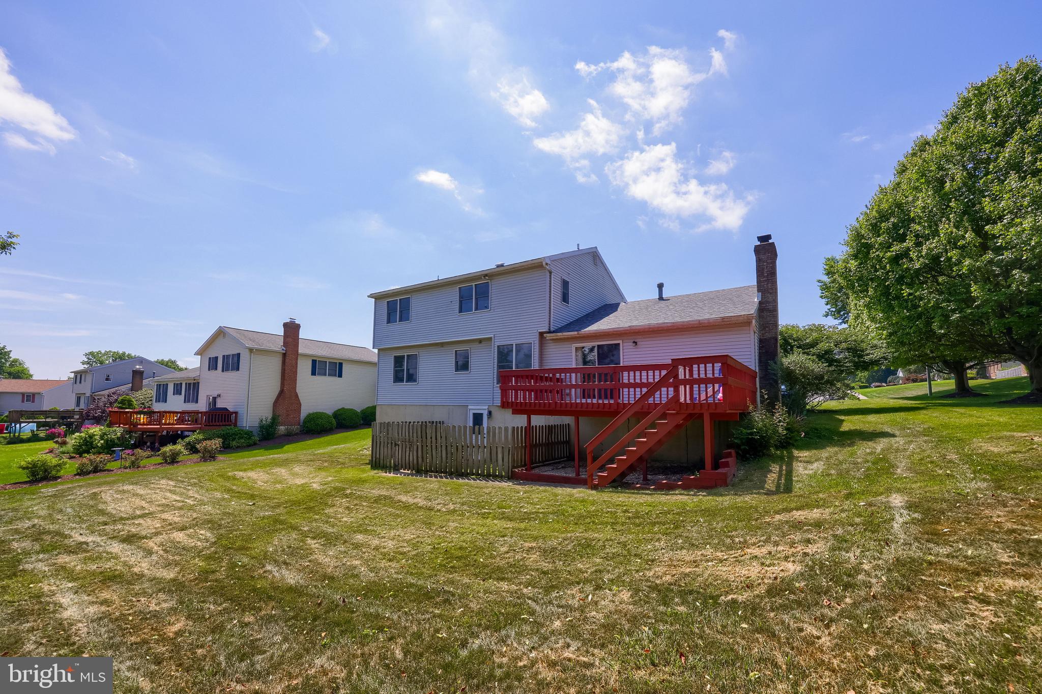 121 Sage Drive Reading, PA 19608 - Photo 36 of 47 a view of a big house with a big yard and a large tree