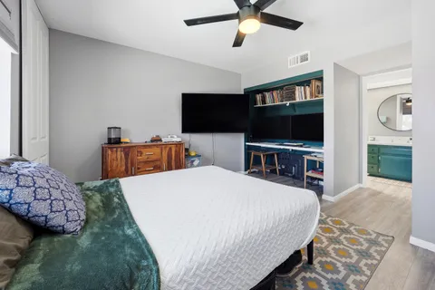 a bedroom with a bed and a flat screen tv