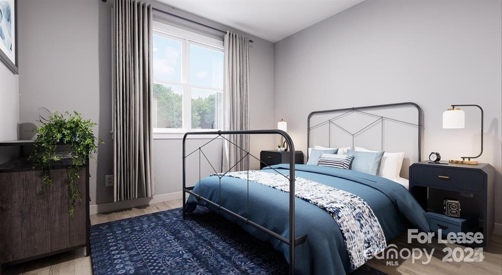 225 Rhyne Road, Unit A1 Charlotte, NC 28214 - Photo 12 of 48 a bed sitting in a bedroom next to a window