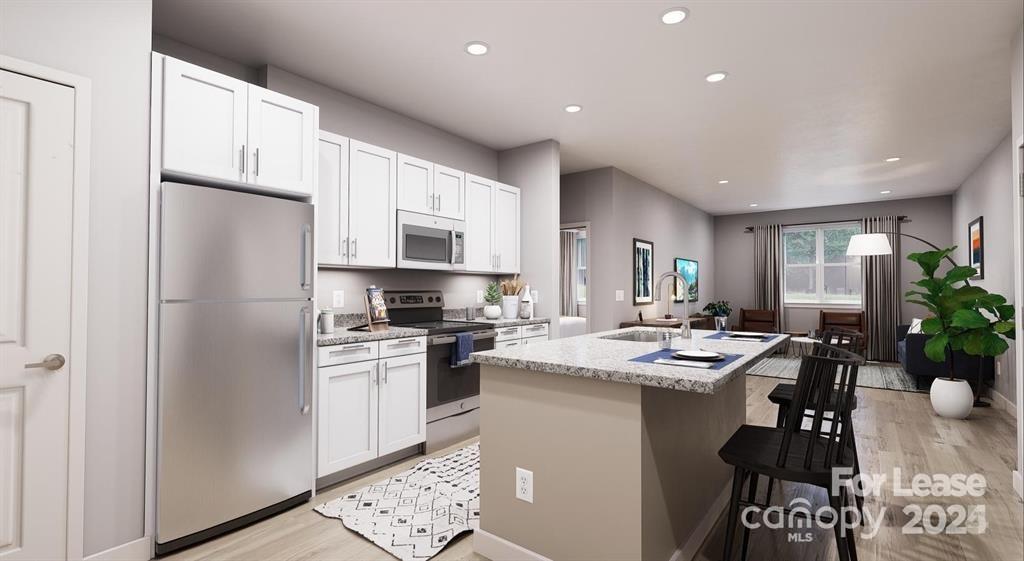 225 Rhyne Road, Unit A1 Charlotte, NC 28214 - Photo 14 of 48 a kitchen with a sink a refrigerator a stove a dining table and chairs