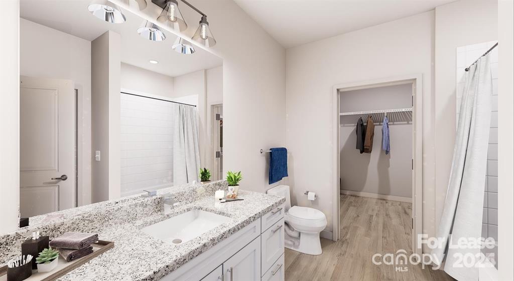 225 Rhyne Road, Unit A1 Charlotte, NC 28214 - Photo 16 of 48 a bathroom with a granite countertop sink and a mirror