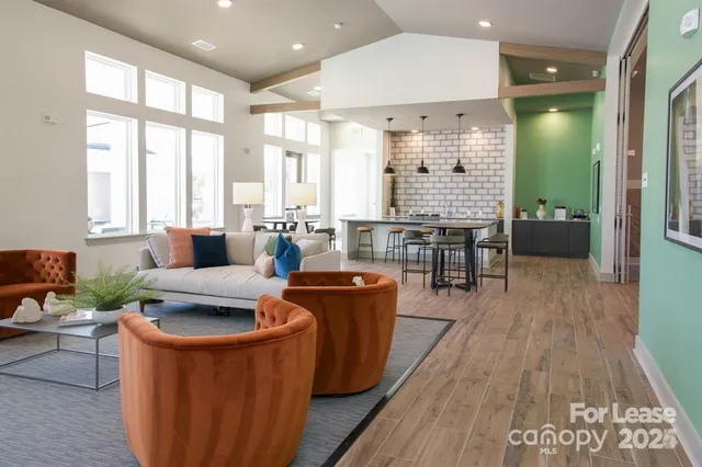 a kitchen with a sink wooden floor and white cabinets