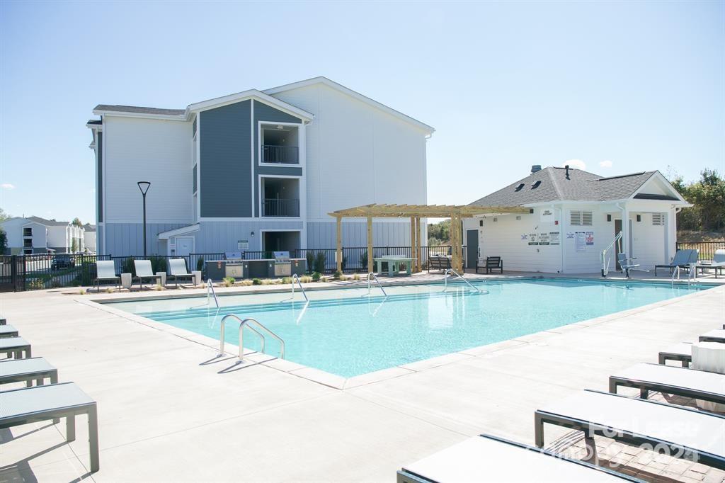 225 Rhyne Road, Unit A1 Charlotte, NC 28214 - Photo 28 of 48 a view of a kitchen with a large window and a table chair