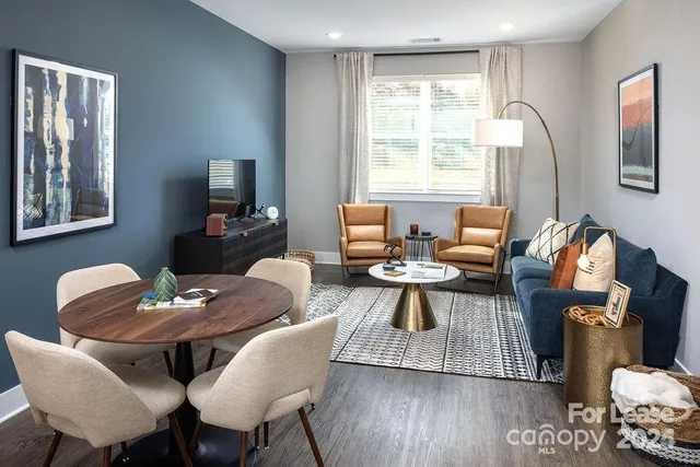 a view of a dining room with furniture window and wooden floor