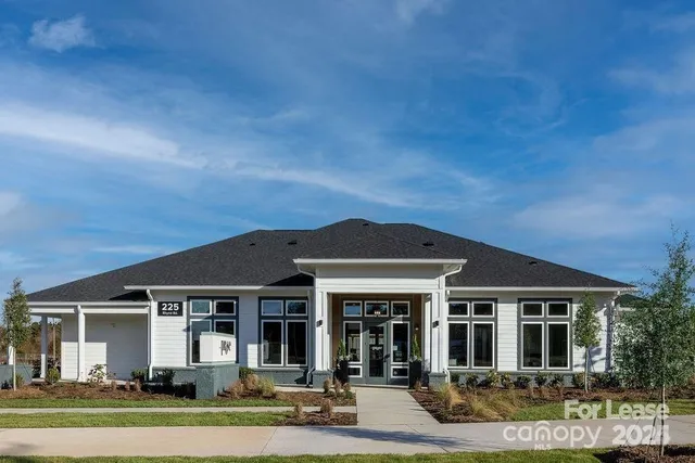 a view of house with outdoor space and swimming pool