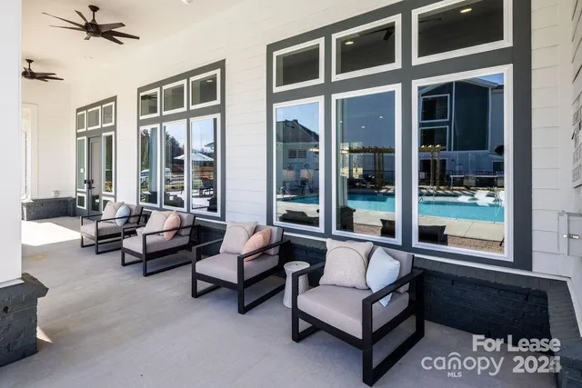 a roof deck with couches and potted plants