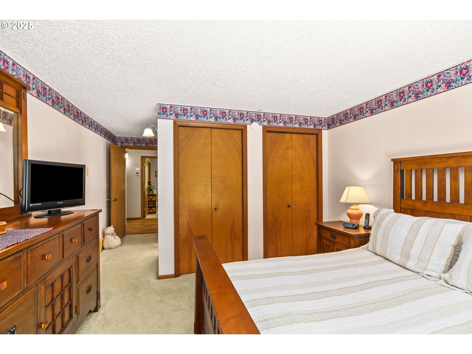 38754 Place Road Fall Creek, OR 97438 - Photo 23 of 48 a bedroom with a bed and a flat screen tv