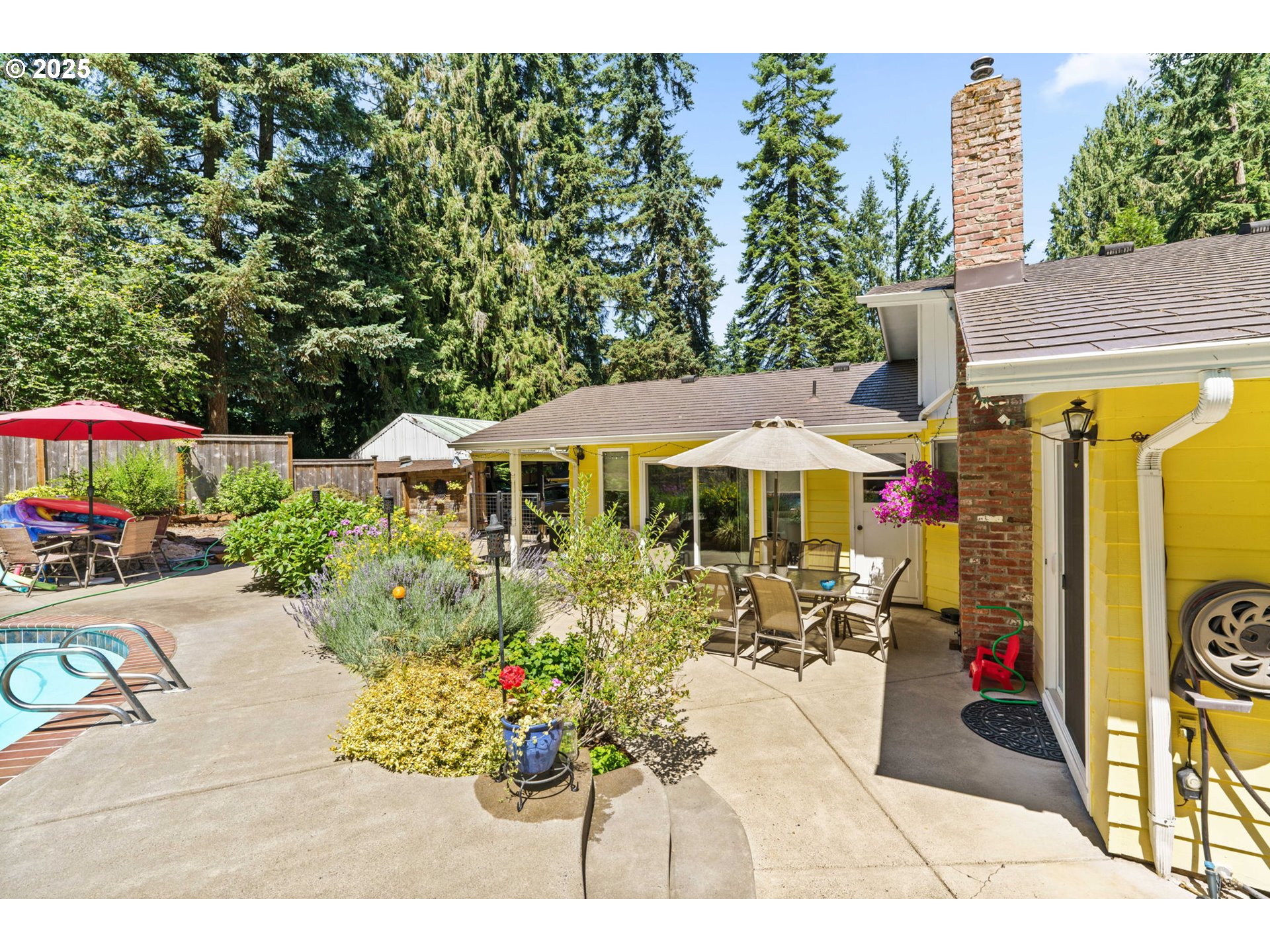 38754 Place Road Fall Creek, OR 97438 - Photo 36 of 48 a view of a patio with table and chairs under an umbrella
