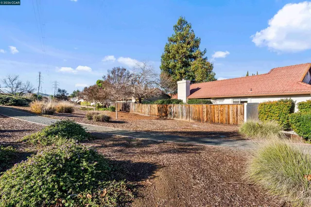 a view of a street with a house in the background