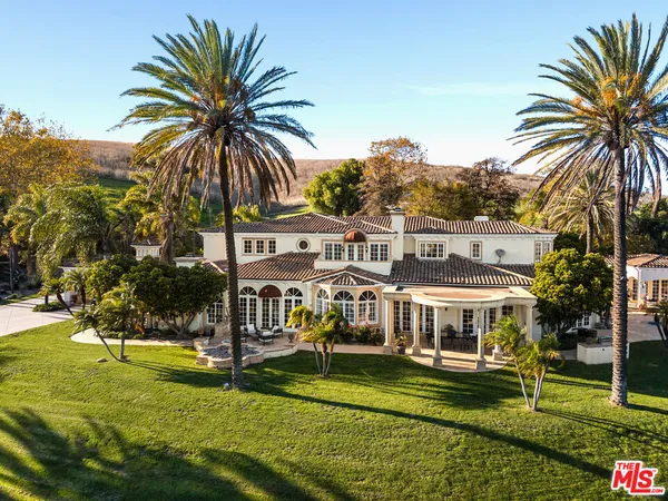 a view of a house with swimming pool and garden