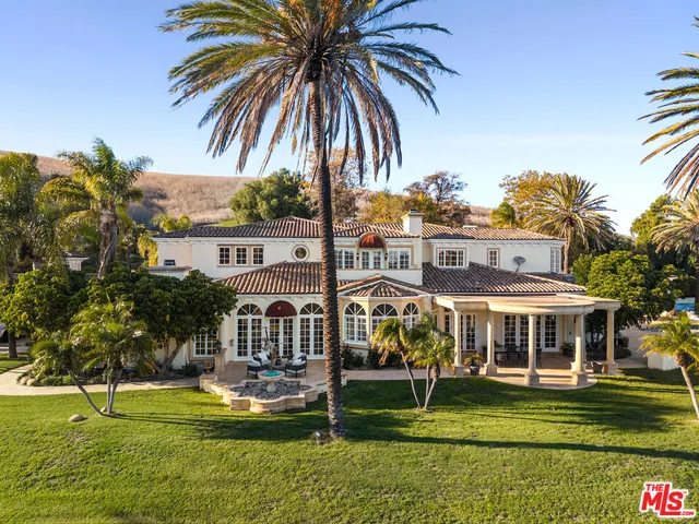 a house with palm tree in front of it