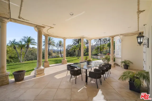 a view of a house with pool and sitting area