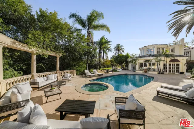 a view of a house with backyard and sitting area