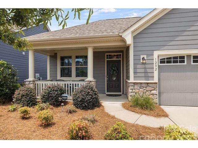 1292 Independence Street Fort Mill, SC 29708 - Photo 1 of 39 a front view of a house with a garden