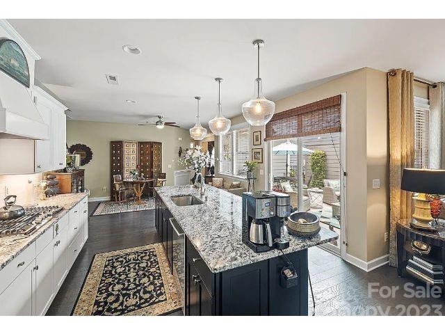 1292 Independence Street Fort Mill, SC 29708 - Photo 12 of 39 a kitchen with granite countertop a stove a sink dishwasher and a wooden cabinets