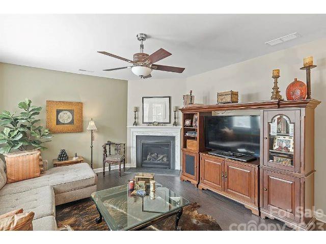 1292 Independence Street Fort Mill, SC 29708 - Photo 17 of 39 a living room with furniture a flat screen tv and a fireplace