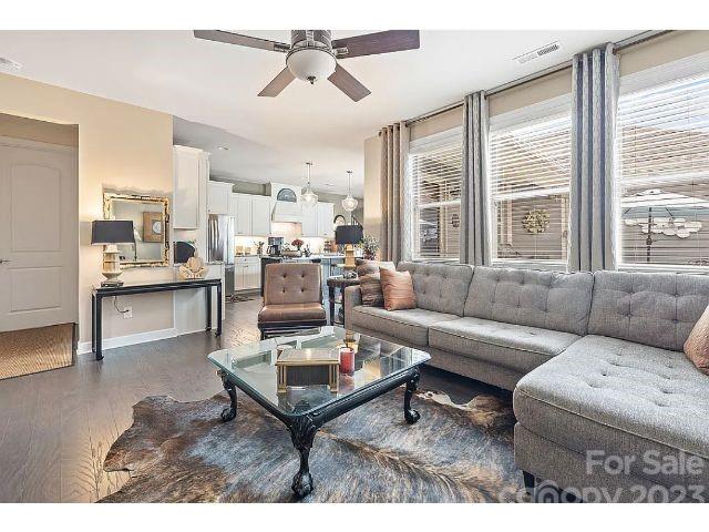 1292 Independence Street Fort Mill, SC 29708 - Photo 19 of 39 a living room with furniture a large window and a chandelier