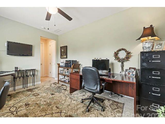 1292 Independence Street Fort Mill, SC 29708 - Photo 22 of 39 a living room with furniture a flat screen tv and a dining table