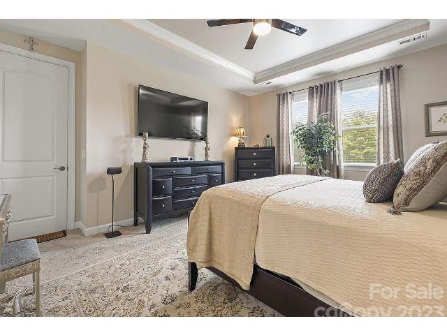 1292 Independence Street Fort Mill, SC 29708 - Photo 26 of 39 a spacious bedroom with a bed and a flat screen tv