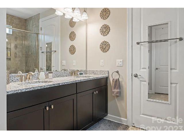 1292 Independence Street Fort Mill, SC 29708 - Photo 27 of 39 a bathroom with a granite countertop sink mirror and a shower