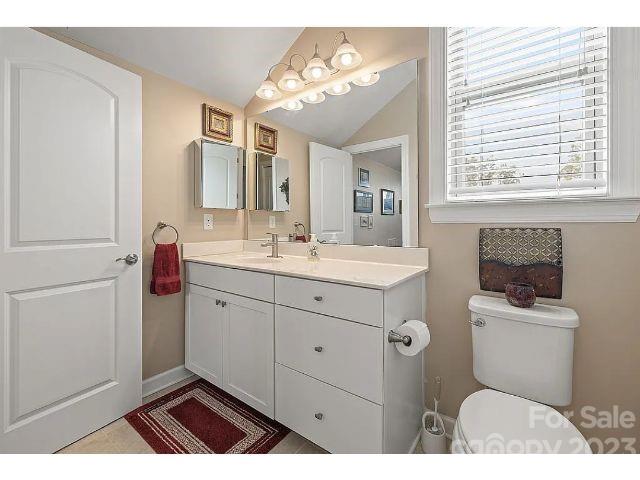 1292 Independence Street Fort Mill, SC 29708 - Photo 37 of 39 a bathroom with a toilet a sink a mirror a vanity and window