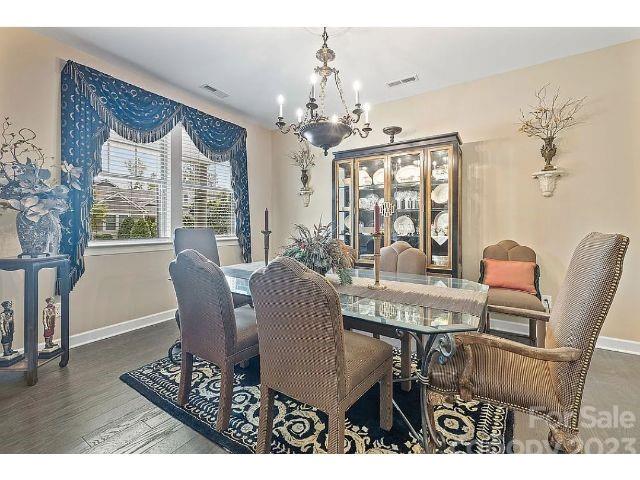 1292 Independence Street Fort Mill, SC 29708 - Photo 7 of 39 a view of a dining room with furniture a chandelier and wooden floor