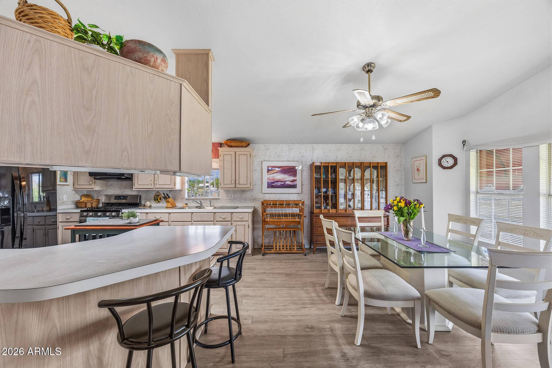 2701 East Utopia Road, Unit 153 Phoenix, AZ 85050 - Photo 11 of 26 a kitchen with a dining table chairs and stove