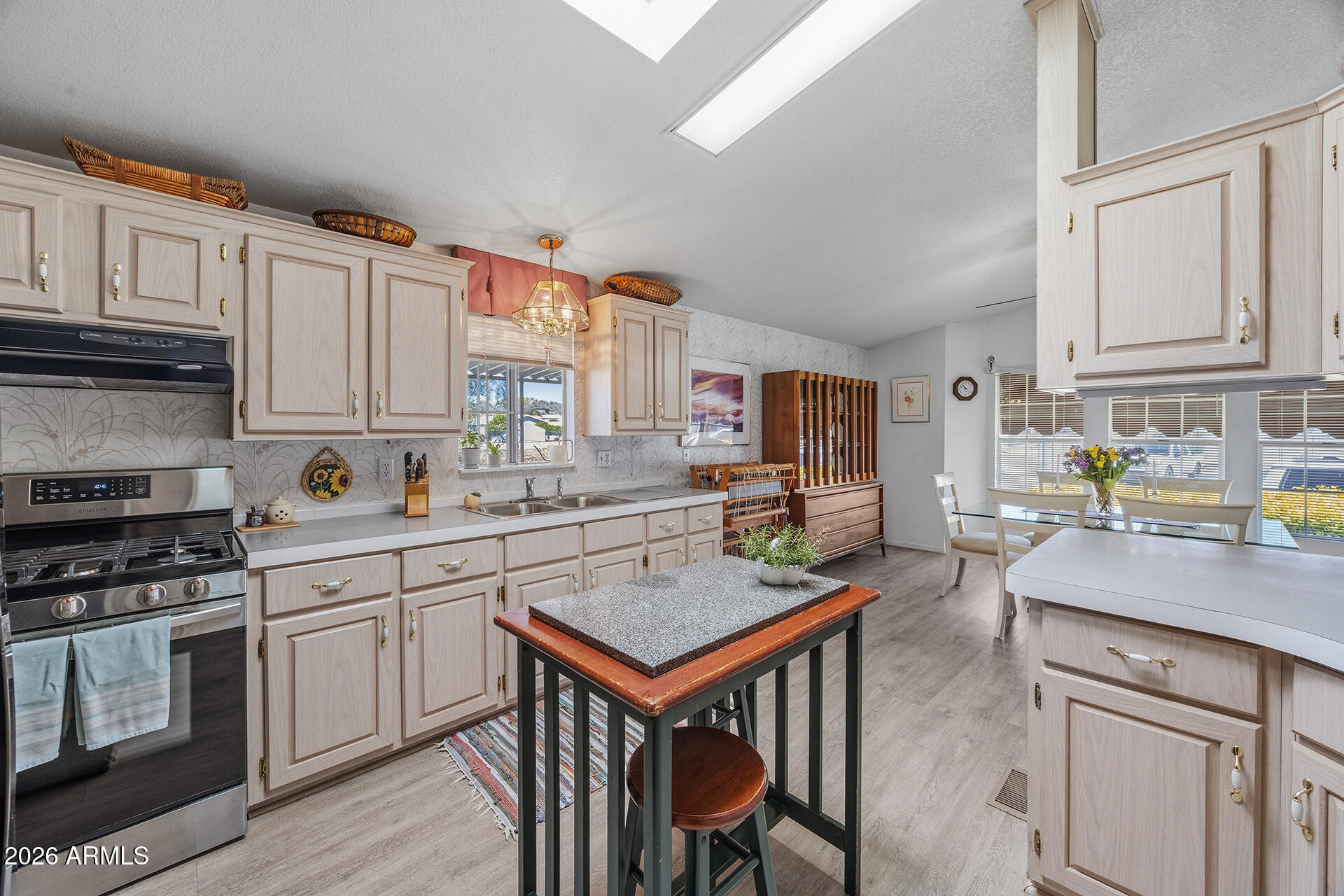 2701 East Utopia Road, Unit 153 Phoenix, AZ 85050 - Photo 15 of 26 a kitchen with stainless steel appliances granite countertop a stove a sink dishwasher and cabinets with wooden floor