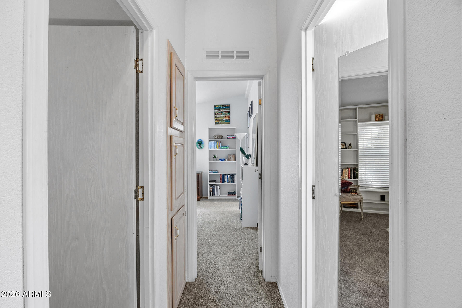 2701 East Utopia Road, Unit 153 Phoenix, AZ 85050 - Photo 16 of 26 a view of a hallway with wooden shelves