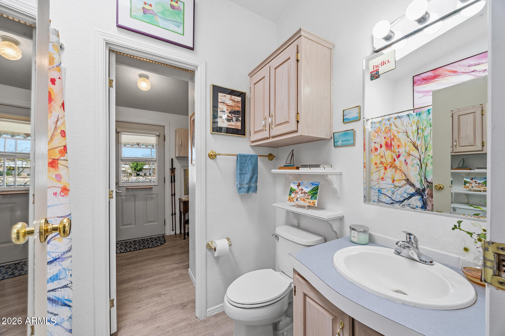 2701 East Utopia Road, Unit 153 Phoenix, AZ 85050 - Photo 17 of 26 a bathroom with a sink a toilet and shower curtain