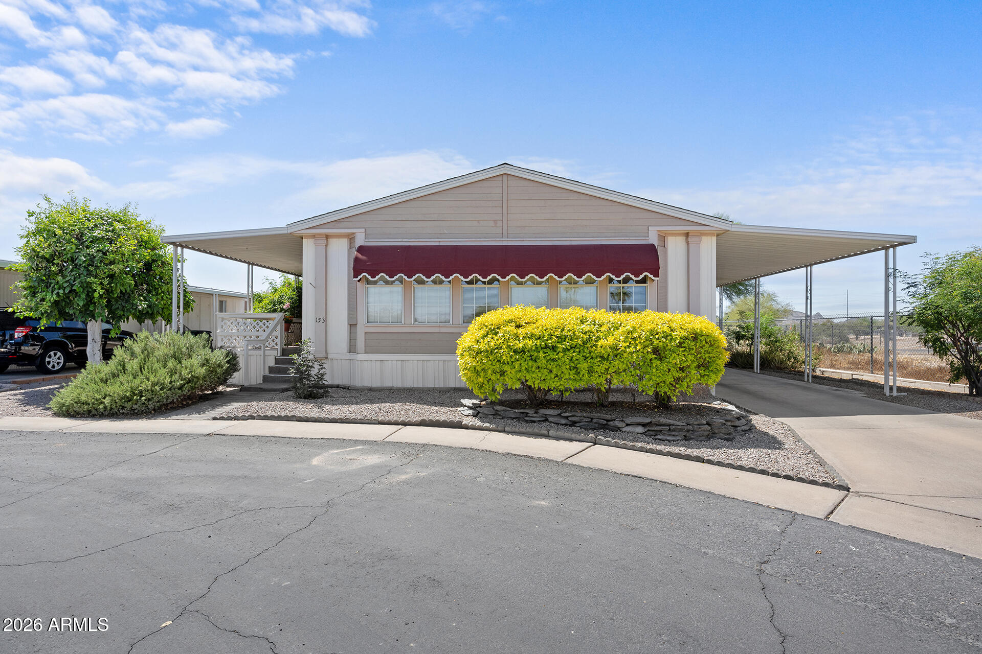 2701 East Utopia Road, Unit 153 Phoenix, AZ 85050 - Photo 2 of 26 a front view of a house with a yard and garage